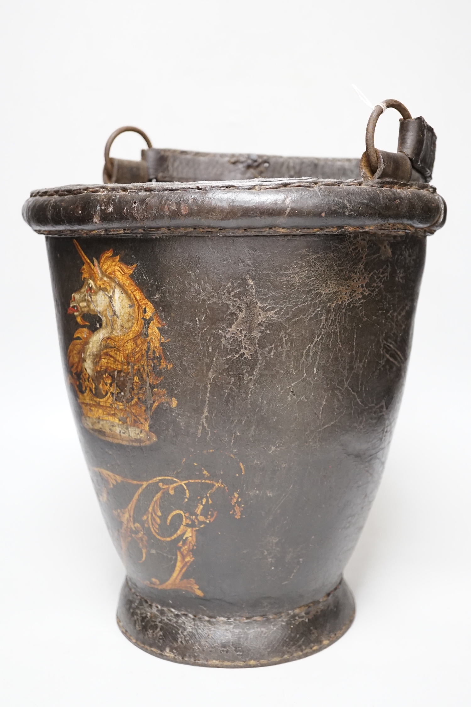 A 19th century leather painted armorial fire bucket, 30cm high